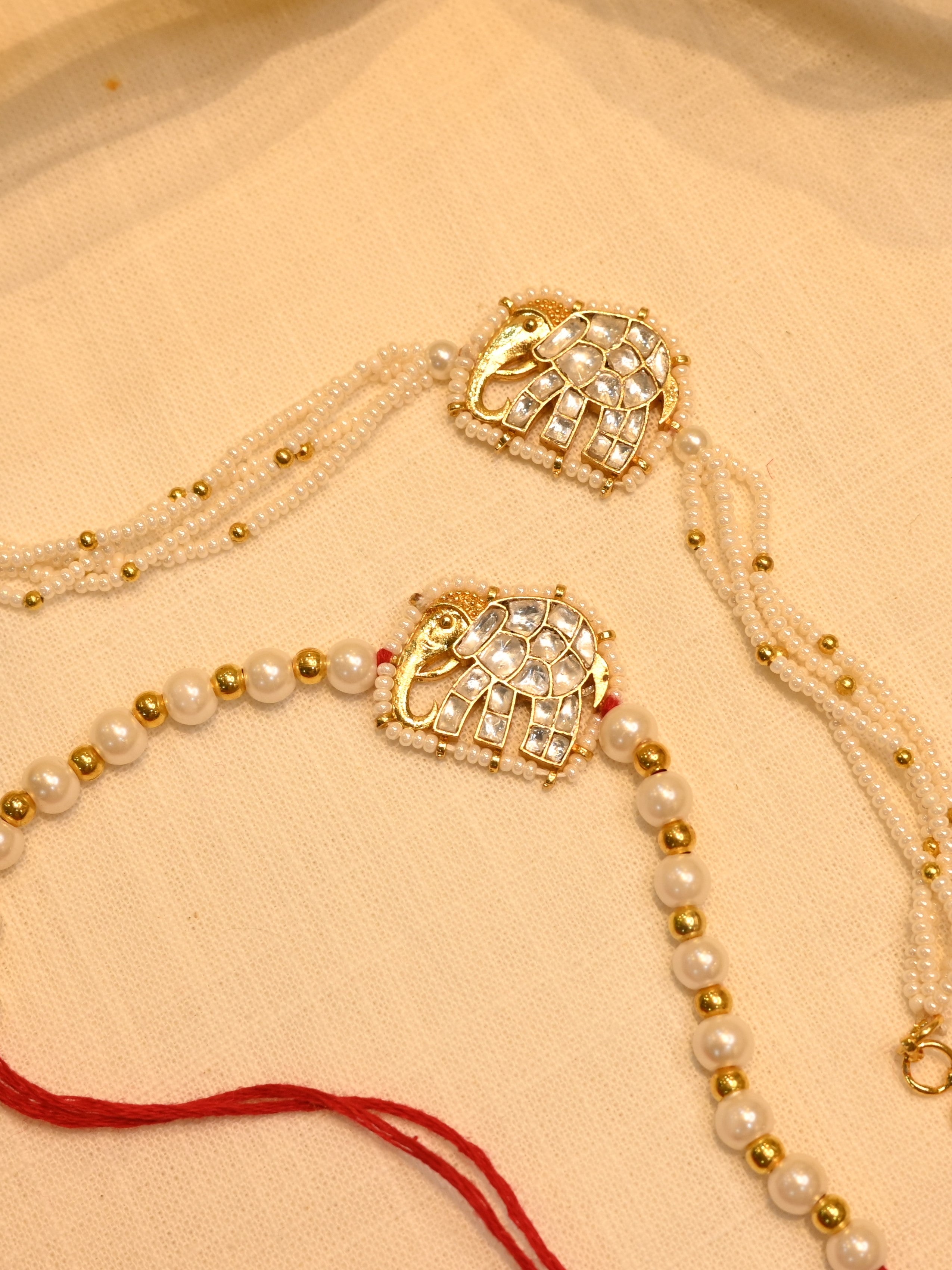 SJRB1011- white Colour Gold Plated Jadau Kundan Couple Elephant Motif Rakhi