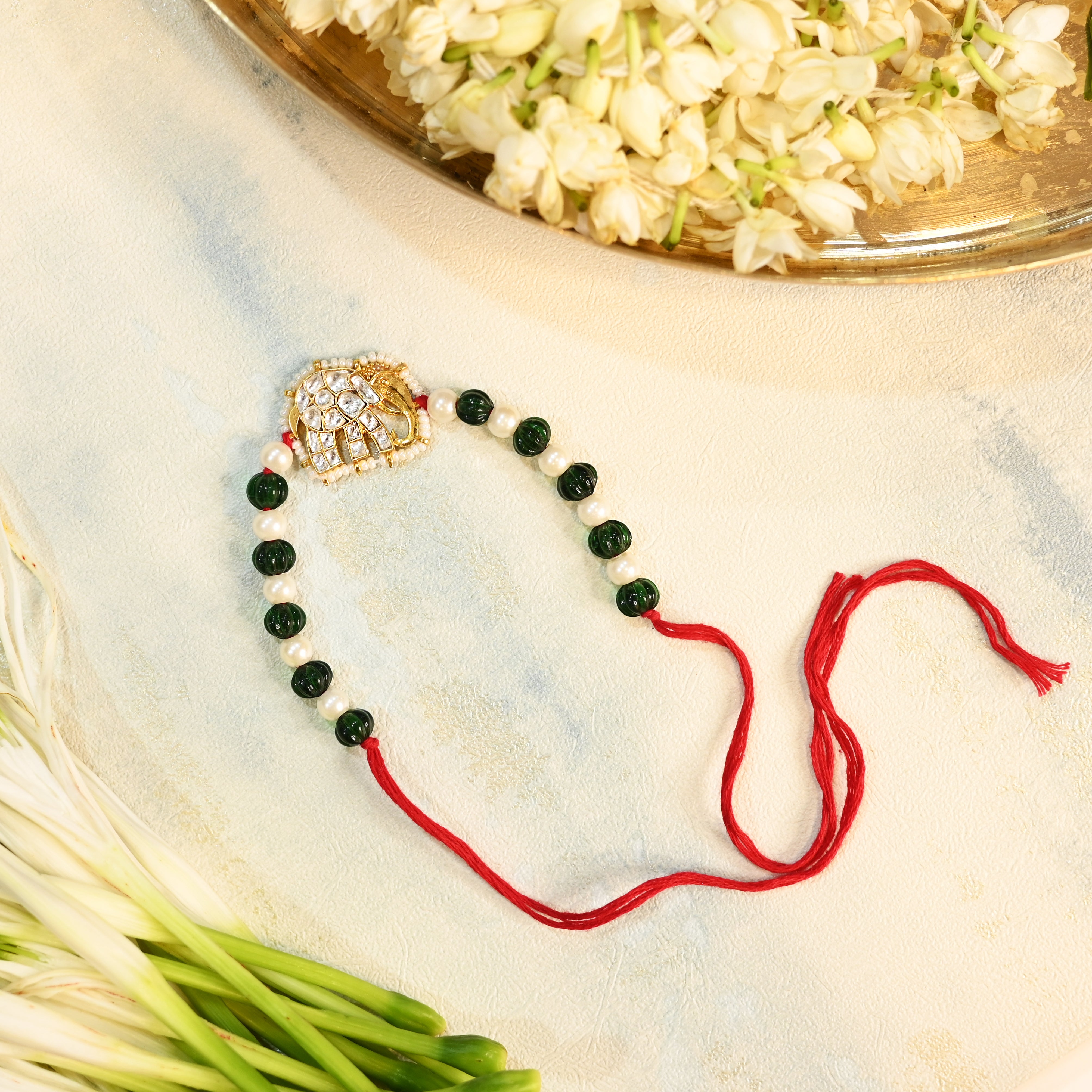 SJRB1015- White and Green Colour Gold Plated Jadau Kundan Elephant Motif Rakhi