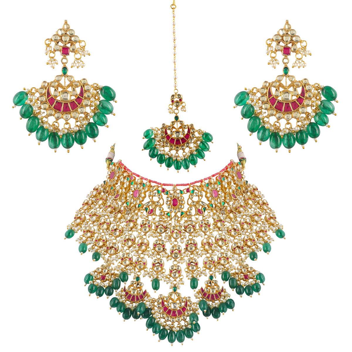 A gold-plated kundan necklace with green and pink stones, accompanied by matching earrings, against a white background.